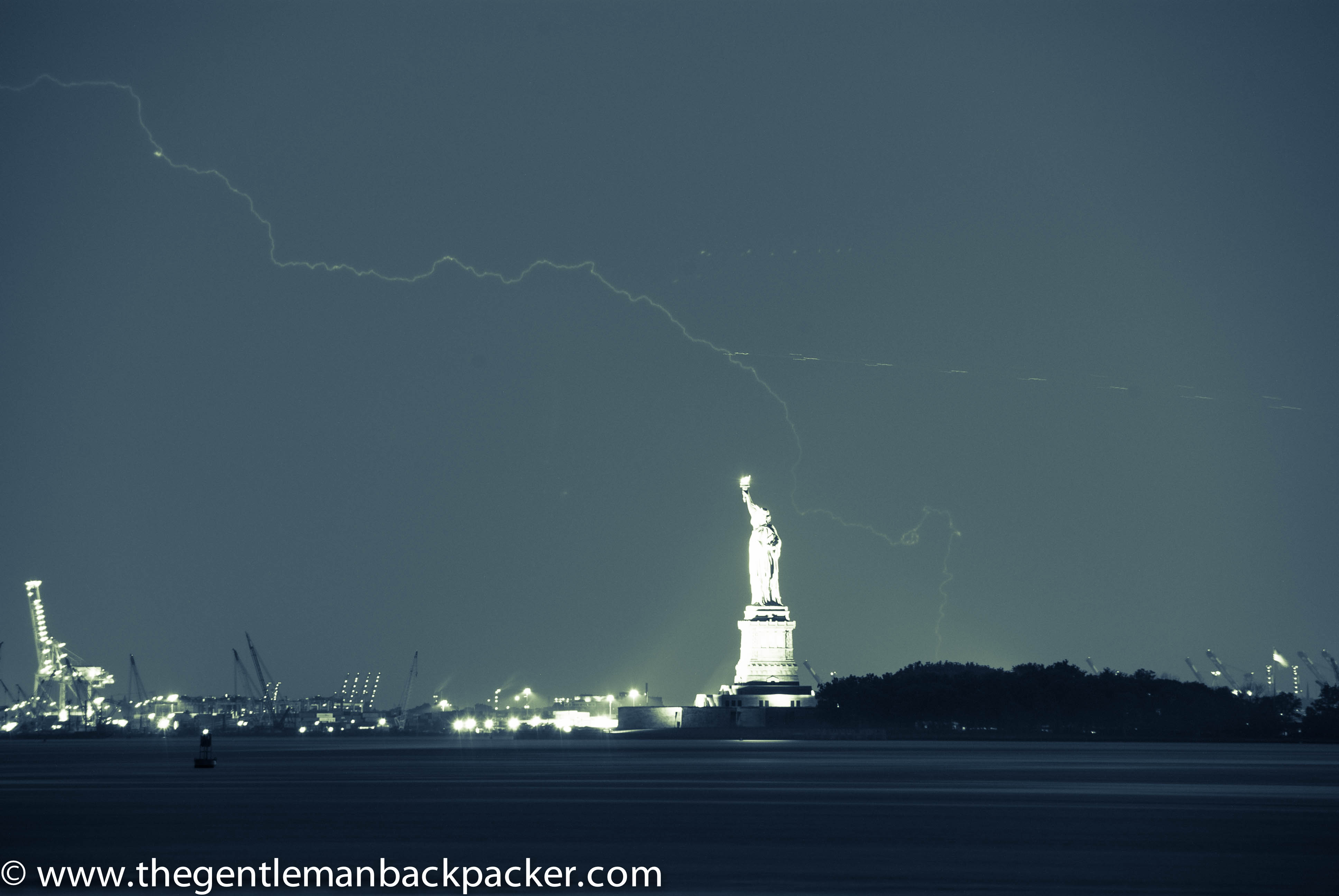 Lightning strike behind the Statue of Liberty